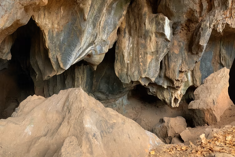 The cave's gaping mouth is a steep descent into its dark chambers. (Image is artists impression).