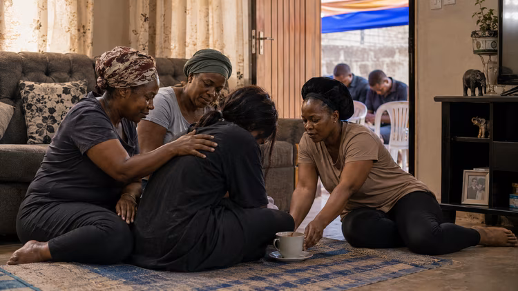 A widow does not mourn alone, the whole room, the whole neighborhood  holds her up. (Image is artists impression).