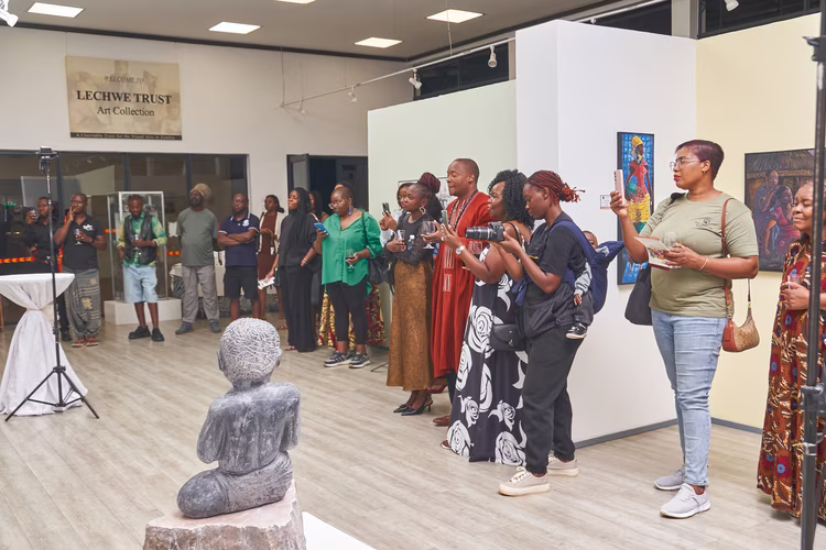 The audience listens intently to welcoming remarks on opening night at Lechwe Trust Gallery. (Image courtesy of Lechwe Trust Gallery).