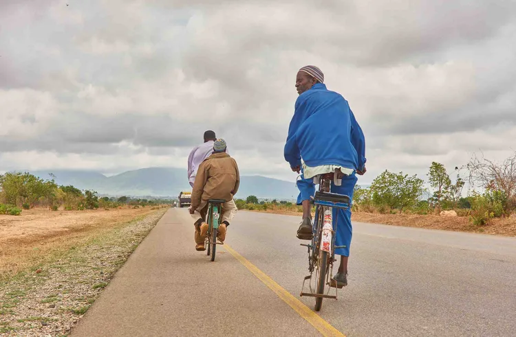 Cyclists go about their day on the road to Chipata (image by Chosa Mweemba).