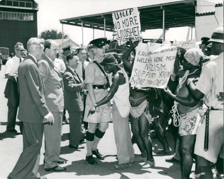 Pro-independence protesters confront Governor Evelyn Hone, ((image courtesy of British Empire).