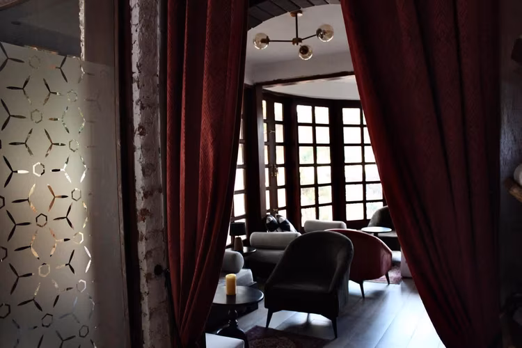 The dim lighting, leather seating and cosy corners give it the feel of a 1950s lounge, while the vines and hanging flowers outside create a secret-garden moment that looks effortlessly romantic on camera. (Image courtesy of Bodega Lusaka).
