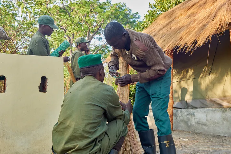 Members of the community work together to maintain the camp. (Image by Nkwazi/Justine Kunda).