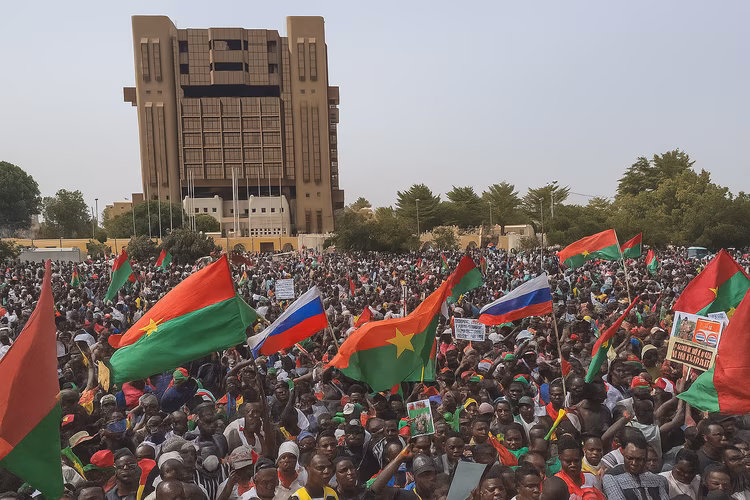 Supporters wave Russian and Burkina Faso flags at a rally in support of Traore.