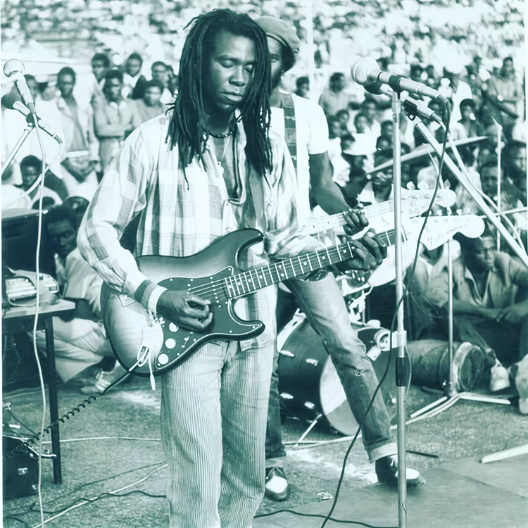 Often dreadlocked and sunglassed or bereted, his fingers moving effortlessly from electric to bass guitar, drums to congas to harmonicas. (Image courtesy of Larry Maluma).