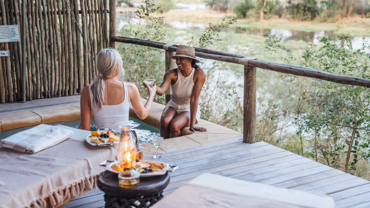 Sip a sundowner on Anabezi’s private deck as the sunset paints the Zambezi gold. (Image courtesy of Dulini Anabezi).