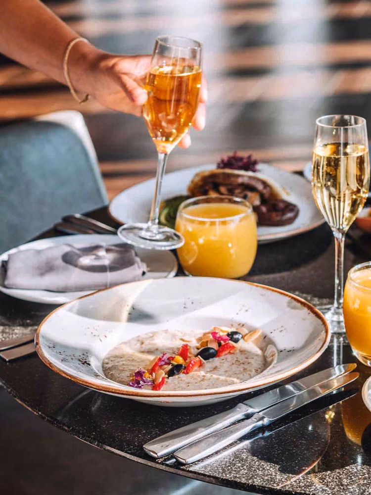 Jo'burg’s skyline glitters beyond the rim of a ‘Bikini Weather’ cocktail, bubbly and bright. (Image courtesy of The Four Seasons Hotel).