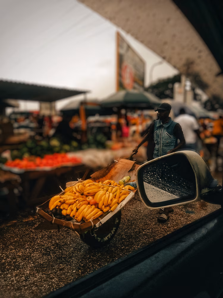 Wheelbarrows rattle past with unique goods being delivered. (Image by Kondwani Phiri).