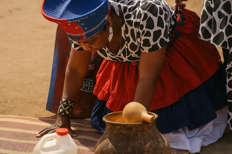 Chieftainess bowing down to pray for rains