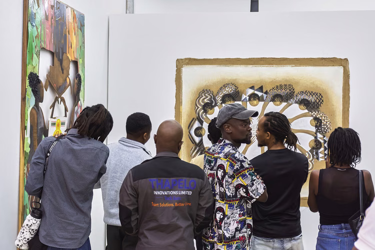The audience ponders  Yombwe’s critique of food  insecurity through mixed-media  works incorporating hessian foodstorage bags. (Image courtesy of Anthony Black).