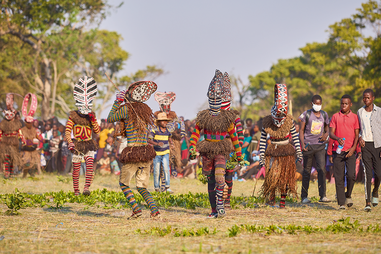 A group of  makishi prepare  to perform  the traditional  kuhunga dance. (Image by Nkwazi/Justine Kunda).