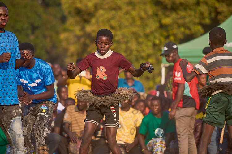 Tundanji perform kuhunga: a special dance performed by  nitiates who have healed and bathed for the first time. Their kilts (jizombo) are made from the bark of the mulende tree. (Image by Nkwazi/Justine Kunda).(Image by Nkwazi/Justine Kunda).