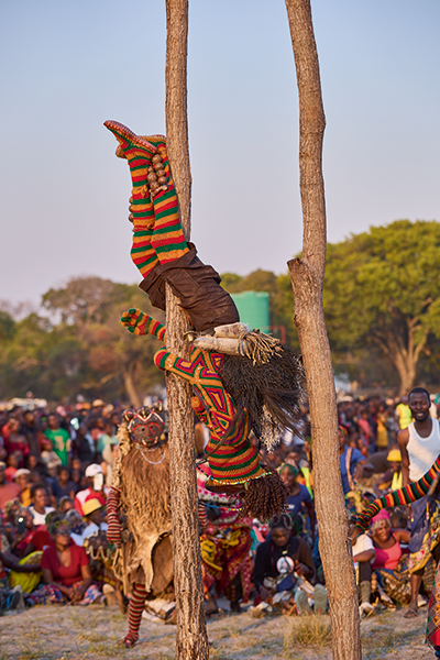 Mwana Pwevo ends his descent from two ten-metre poles. He selects the poles and erects them himself. It is taboo to walk between them.