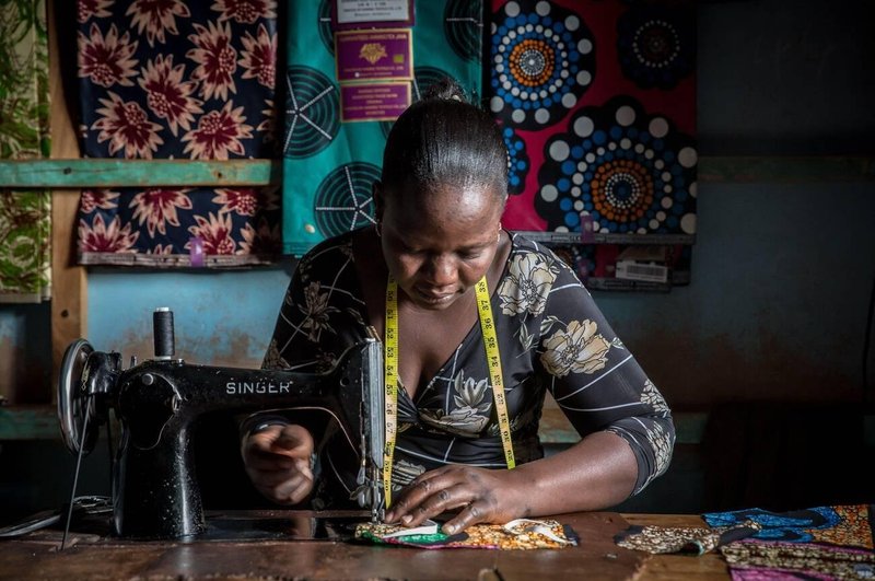 African tailor working with chitenge fabric (SOPA Images/Alamy)