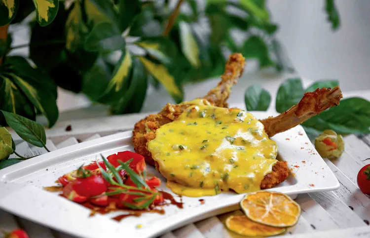 Pork Schnitzel served with a Cheese Sauce at Le Elementos Boutique Hotel. (Image by Nkwazi/Justine Kunda).