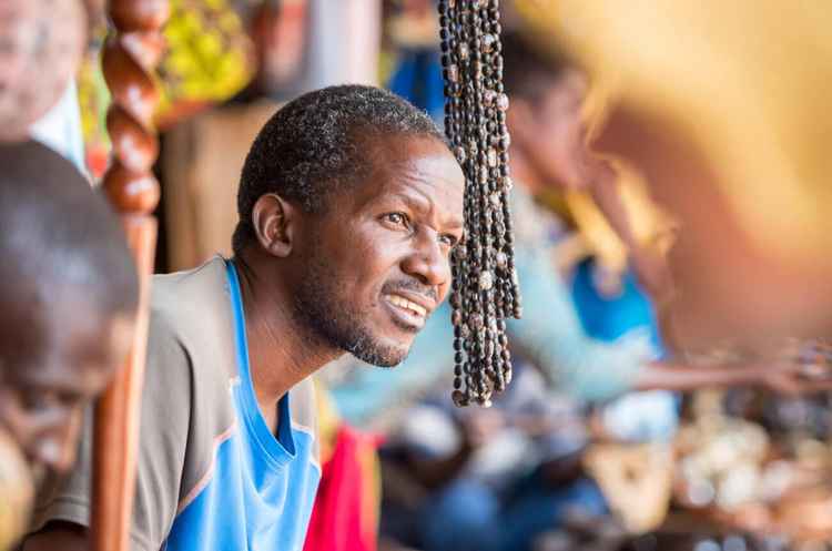 A vendor at Mukuni Village who makes and sells souvenirs for tourists (Image by Edwin Remsberg)